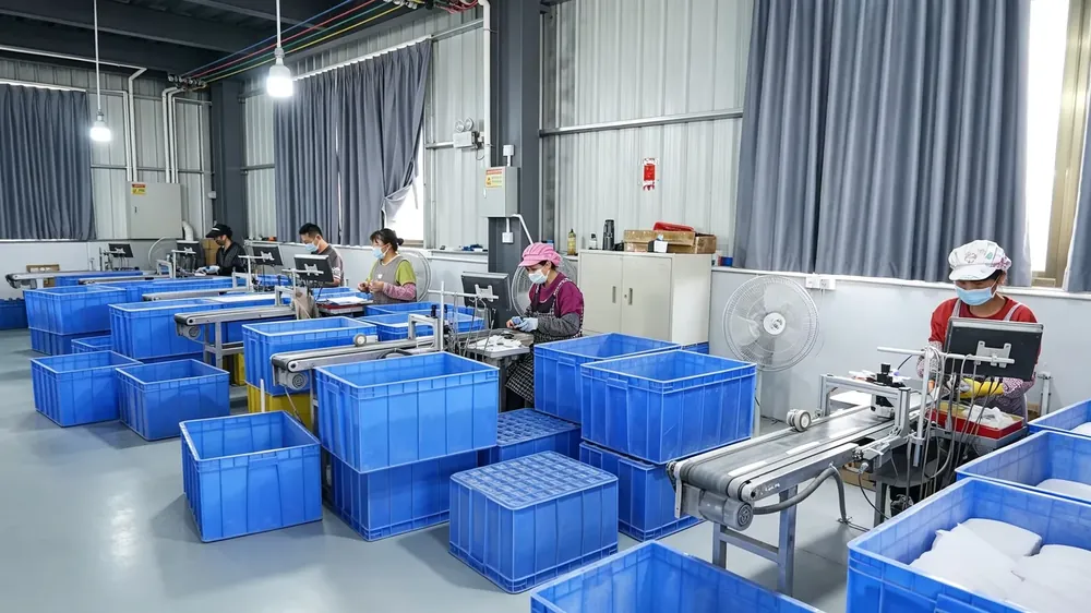 Operators at the logo printing station on the workshop floor