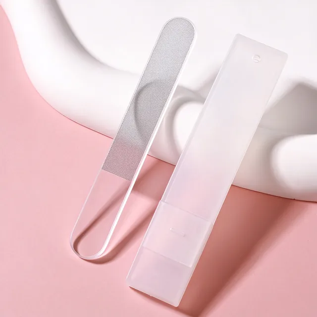 Two glass nail files, one clear and one frosted, resting on a white dish