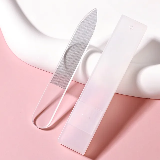 A clear and a frosted glass nail file crossed on a pink background