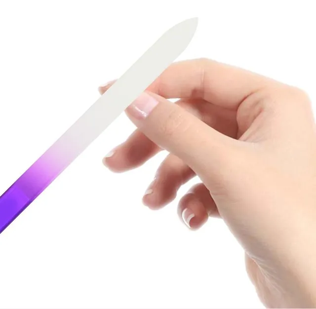 Hand holding a purple gradient glass nail file by its handle end
