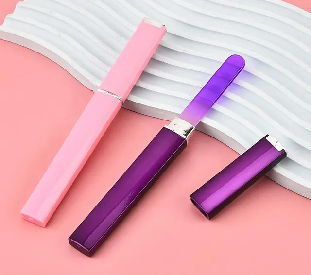 Two gradient glass nail files with their matching pink and purple storage cases