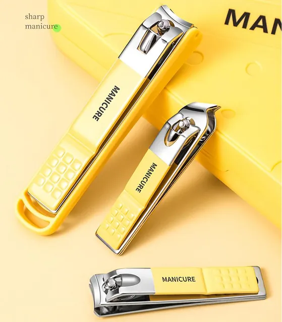Yellow nail clippers with the shaped texture on their handles, on a yellow surface
