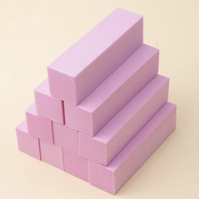 Four-sided sanding blocks in pink and in blue stacked into a pyramid