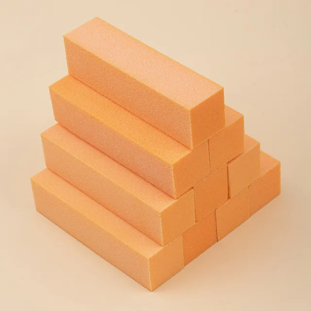 Four-sided sanding blocks in green, blue and orange arranged in two groups