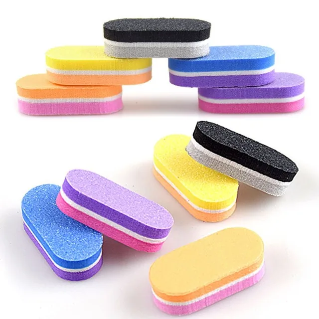 Assorted mini buffer blocks in black, yellow, blue, orange, pink and purple scattered on a white background