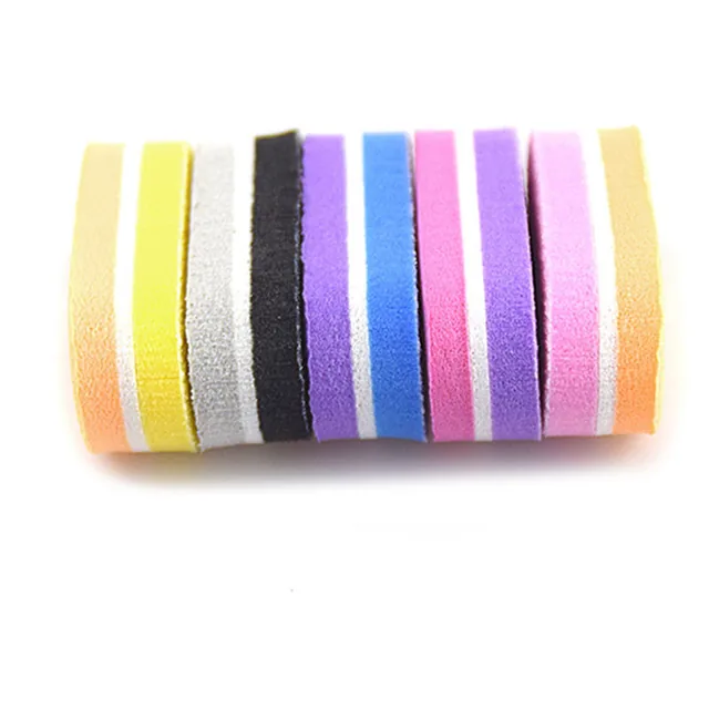 Row of mini buffer blocks standing on edge to show the layered sponge and abrasive faces