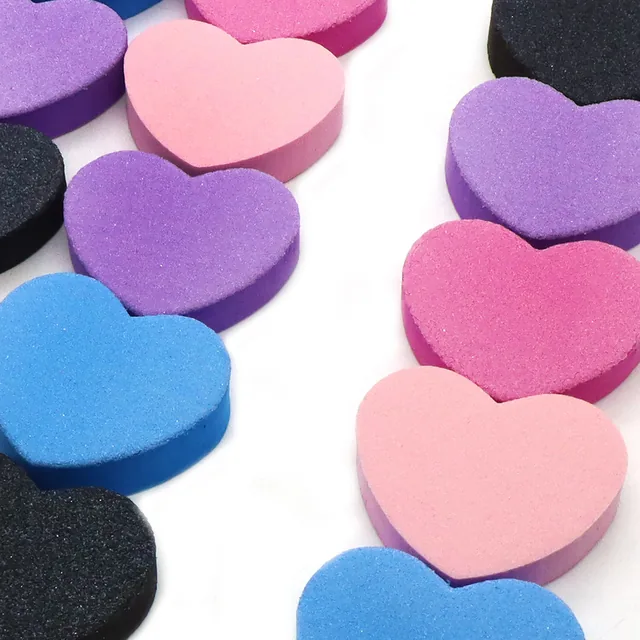 Heart-shaped blocks in purple, pink, blue and black arranged across a white background