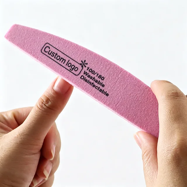 Half-moon sponge nail file held in the hand showing the curved profile