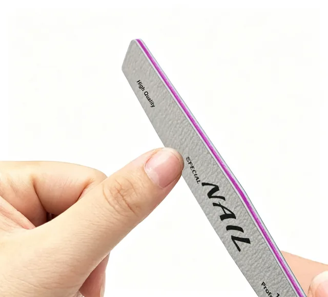 Hand holding one grey professional nail file showing the printed face