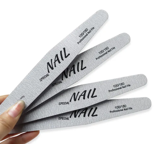 Four grey professional nail files fanned in the hand