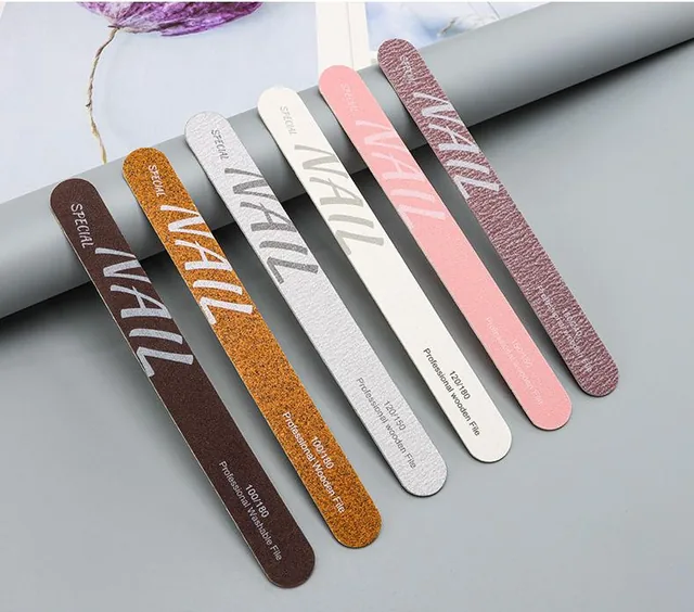 Six wooden nail files leaning on a grey mat with Special Nail wording along their faces