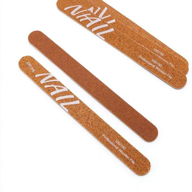 Three orange 100/180 wooden nail files arranged on a white background