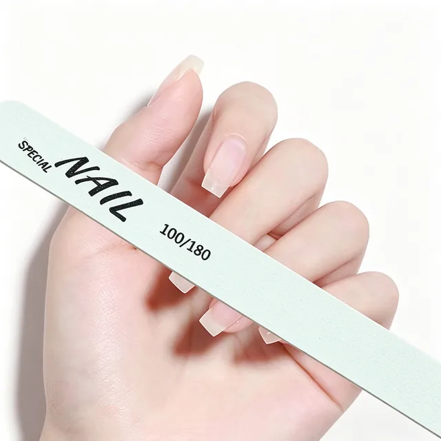 Hand holding the pale mint printed wooden nail file with Special Nail and 100/180 on the face