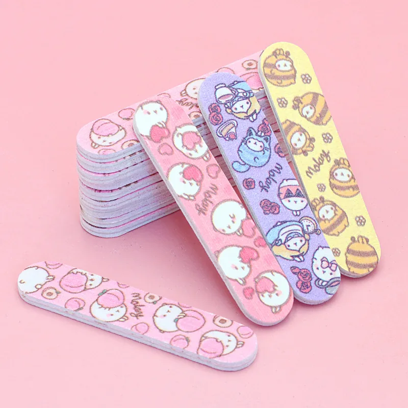 Mini cartoon-print nail files in pink, lilac and yellow fanned out on a pink background