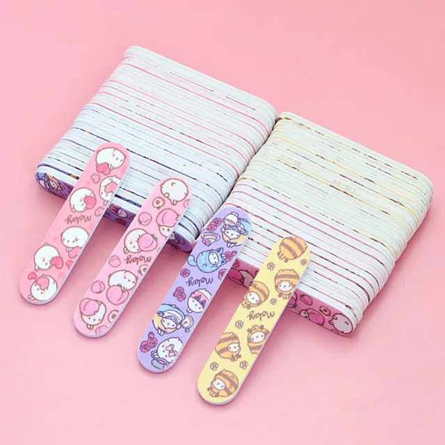 Four mini cartoon-print nail files fanned across two block stacks of plain files