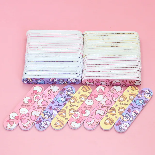 Mini cartoon-print nail files in four designs fanned in front of two block stacks